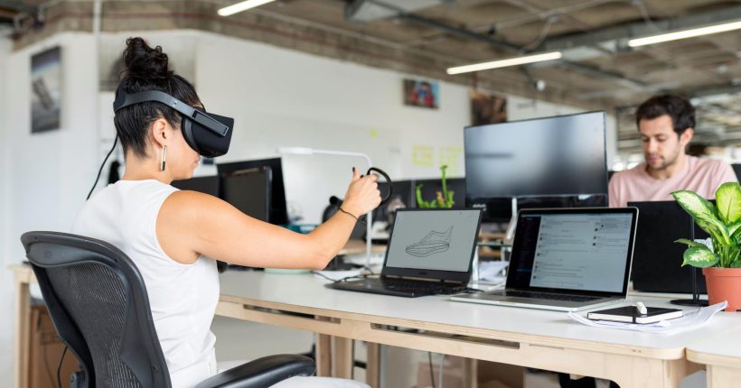 woman using laptop computer with vr headset