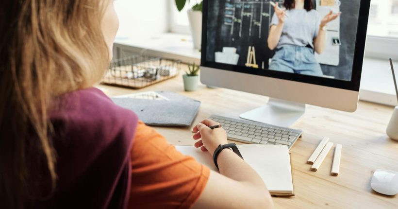 photo of girl watching through imac