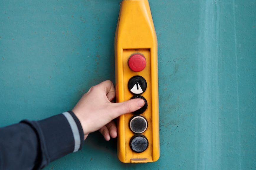 a hand clicking the buttons of the control panel