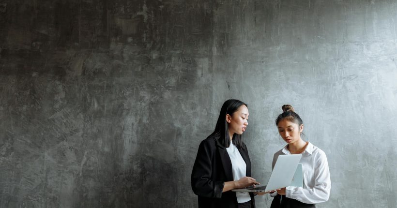 man in black coat standing beside woman in white long sleeve shirt