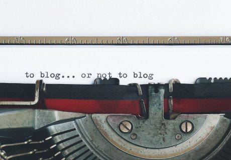Classic typewriter with 'to blog or not to blog' typed on paper.