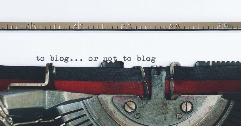 Classic typewriter with 'to blog or not to blog' typed on paper.