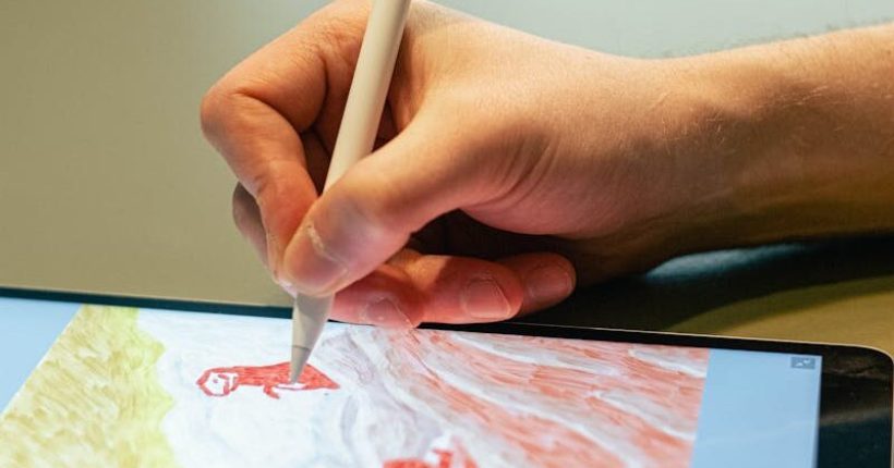 Close-up of hand drawing on tablet screen with stylus, showcasing digital artistry.