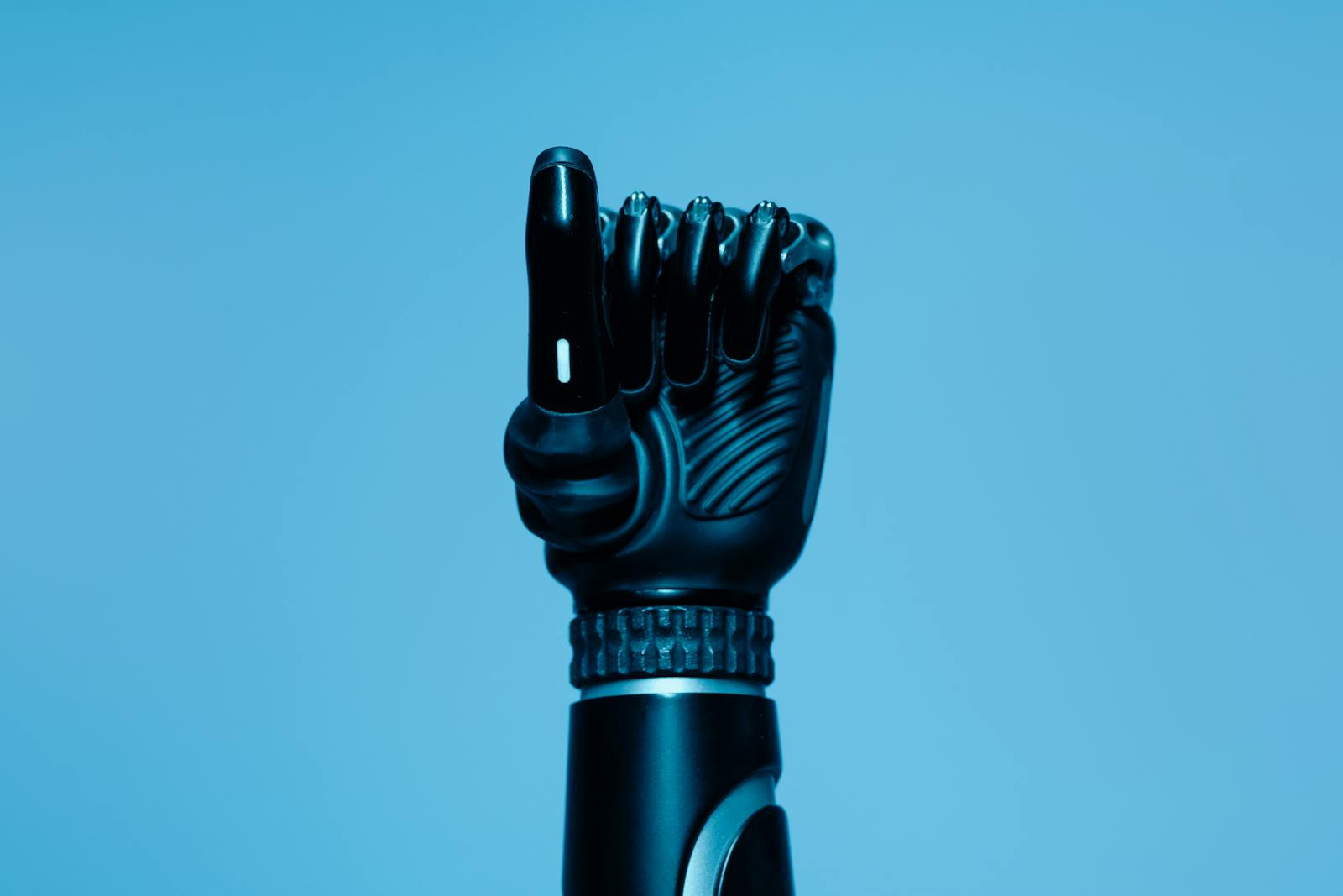 Close-up of a prosthetic arm in a vibrant blue setting, showcasing advanced technology.