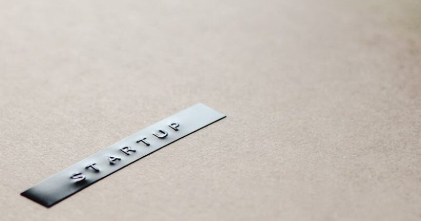 Close-up of a startup label on a minimalist brown background, emphasizing entrepreneurship.