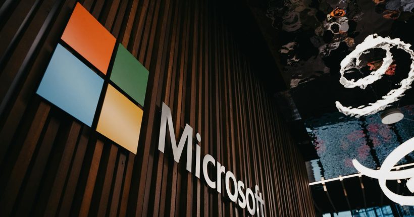 Interior view of Microsoft office with logo on wooden wall in Brussels, Belgium.