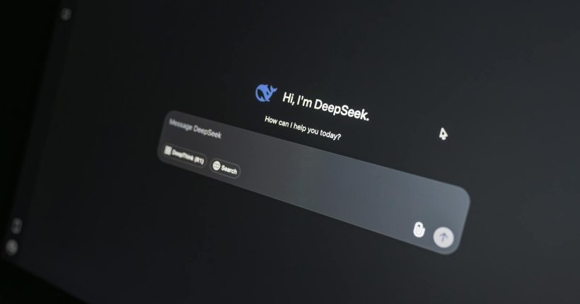 Close-up of DeepSeek AI chat interface on a laptop screen in low light.