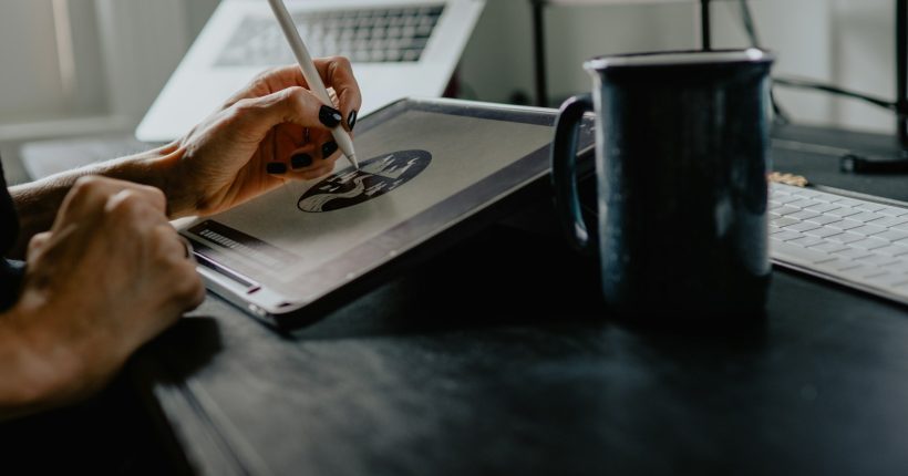 person holding silver fork on white paper