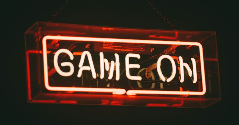 red and white Game On LED signage