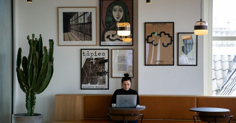 woman in black long sleeve shirt sitting on brown wooden chair