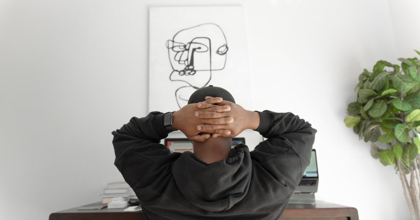 man in gray hoodie sitting on chair