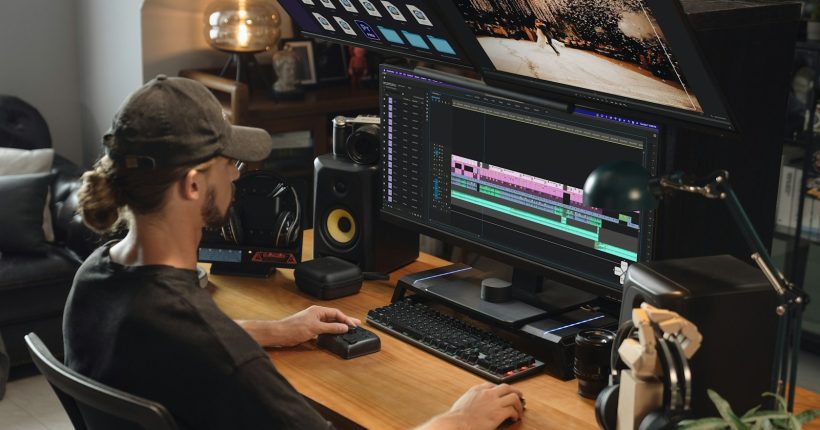 A man edits video on a computer.
