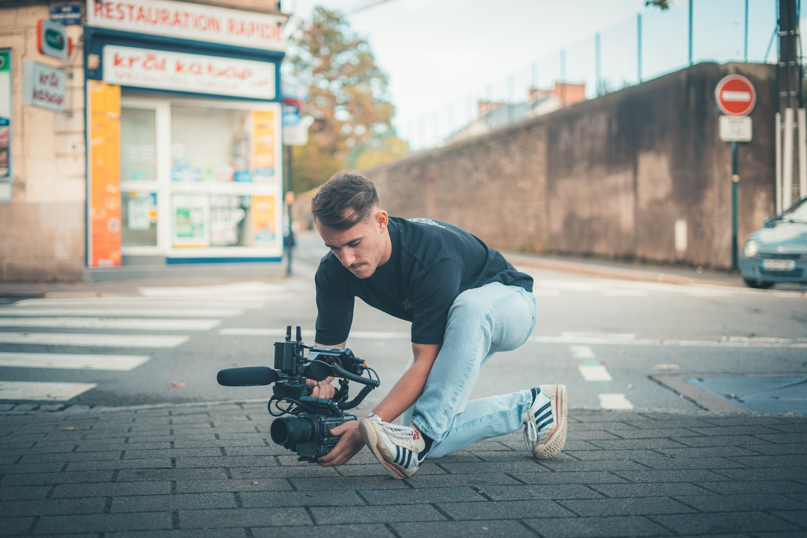 Man filming with a professional camera on the street