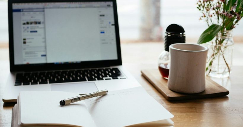 MacBook Pro near white open book