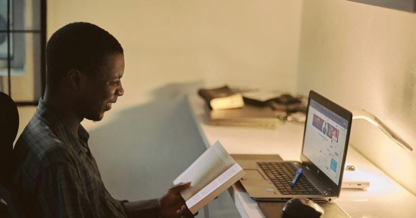 man in black dress shirt using laptop computer