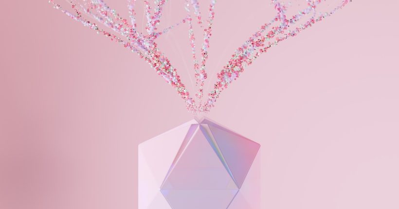 a crystal vase with pink flowers in it