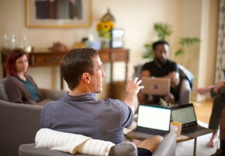 man in gray sweater sitting on couch