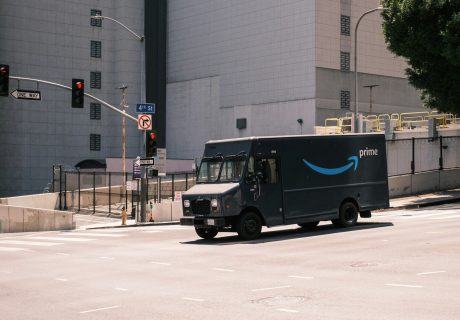 blue and white van parked near white building during daytime