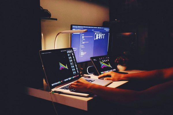 woman in black tank top sitting in front of computer