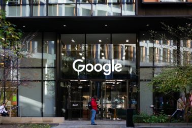a man standing in front of a google building