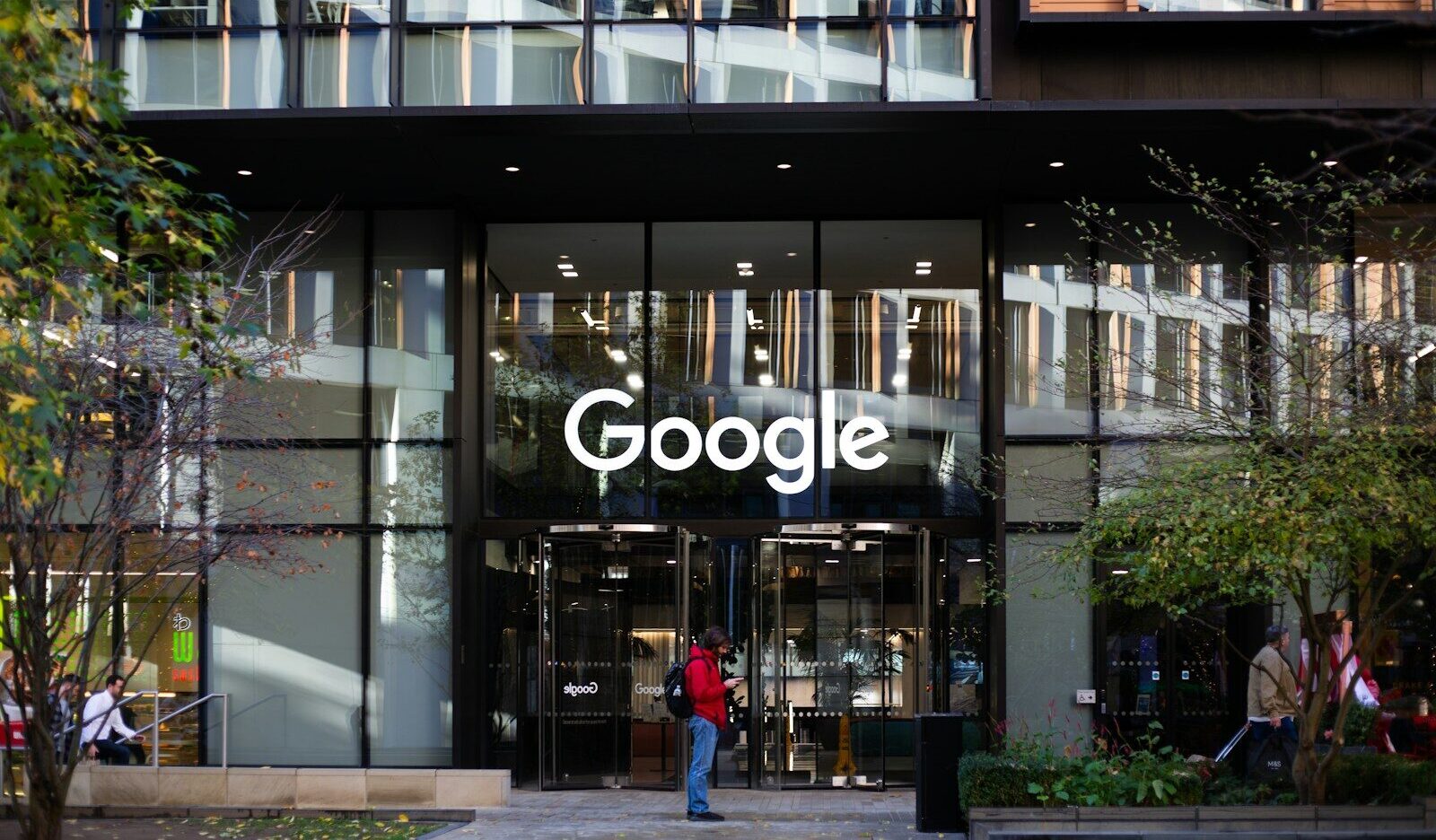 a man standing in front of a google building