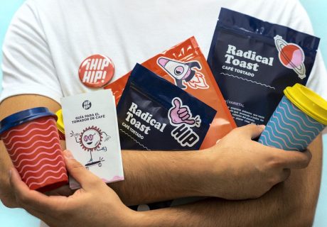 a man holding a cup of coffee and some snacks