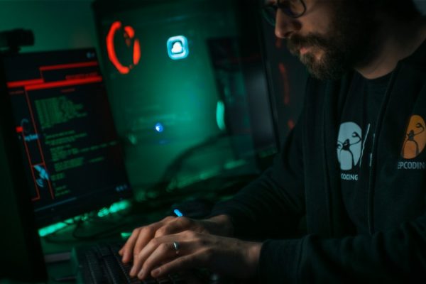 man in black jacket using computer