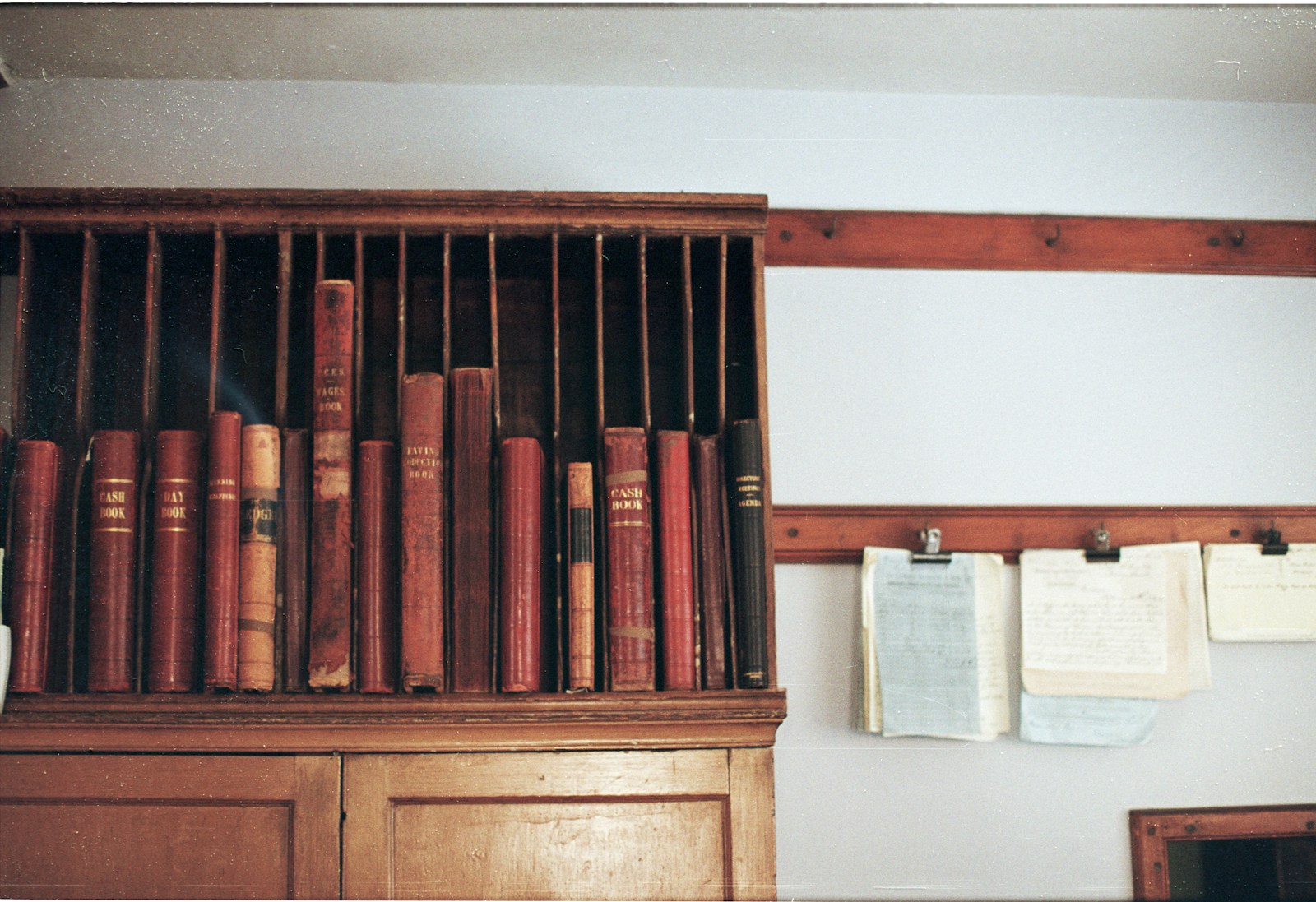 Wooden shelf filled with antique books