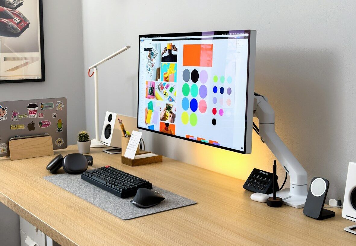a computer monitor sitting on top of a wooden desk