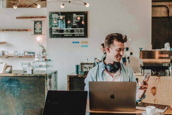 man using smartphone smiling