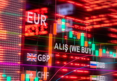 Dynamic forex trading concept with currency symbols and candlestick chart illuminated on screen.