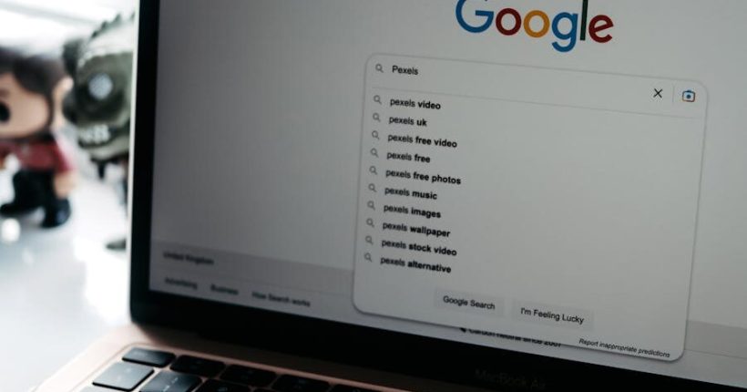 A close-up shot of a laptop displaying a Google search page with related searches visible.