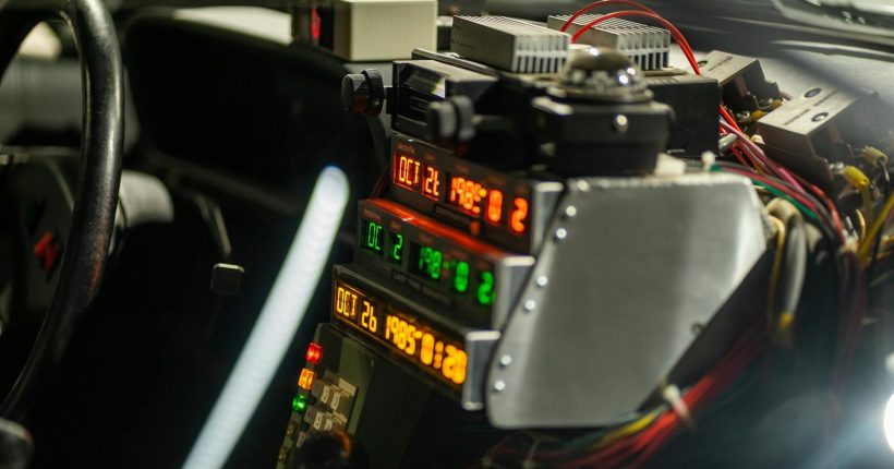 Intricate car dashboard featuring futuristic time-travel display and controls, evoking a sci-fi vibe.