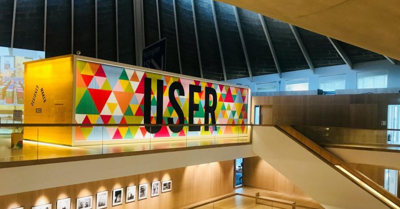 Spacious modern gallery in London featuring vibrant user typography and geometric design elements.