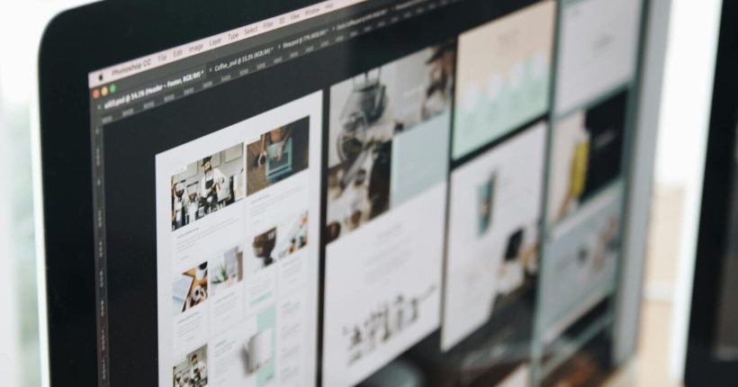 A modern computer screen displaying web design work, showcasing creative visuals in a workspace.
