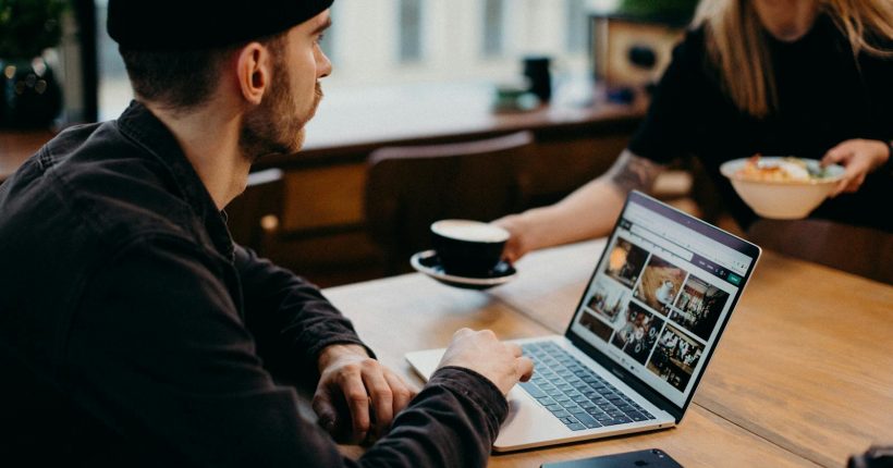 Freelancer working on a laptop in a cozy café setting. Ideal for remote work themes.