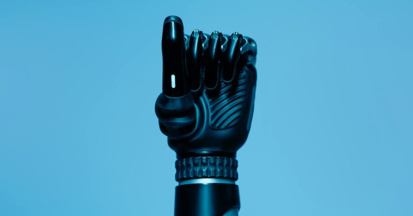 Close-up of a prosthetic arm in a vibrant blue setting, showcasing advanced technology.
