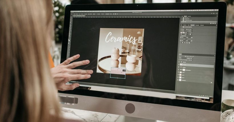 A graphic designer works on a ceramics promotion using Adobe Photoshop on an iMac.