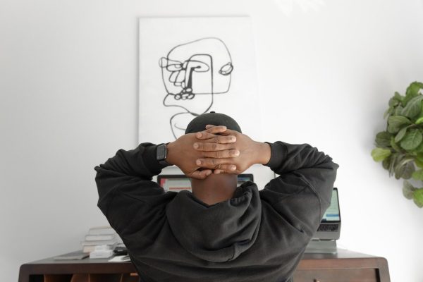 man in gray hoodie sitting on chair