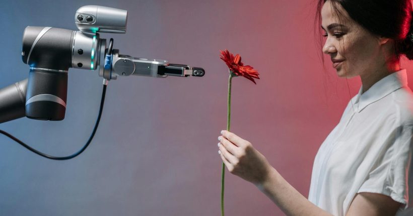 A woman receives a red flower from a robotic arm symbolizing harmony of technology and nature.