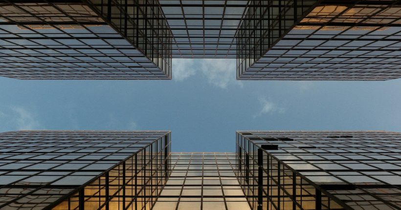 worm view photo of buildings under cloudy sky