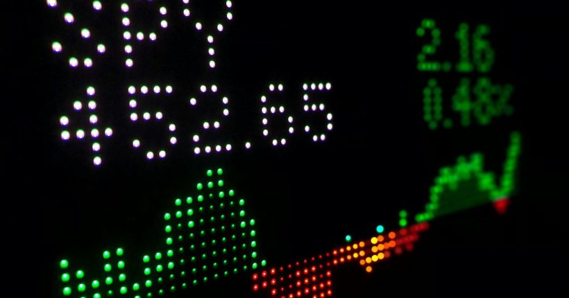 a close up of a clock with different colored numbers