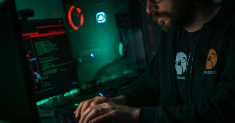 man in black jacket using computer