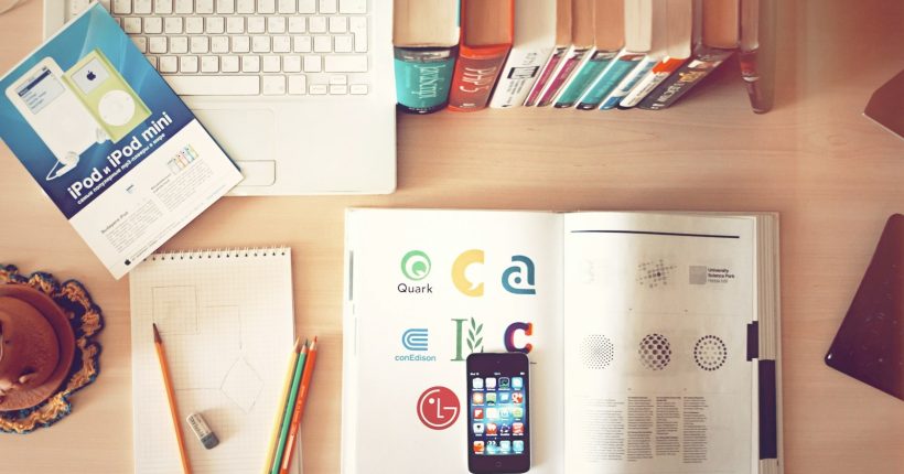 pencils and smartphone on top of books