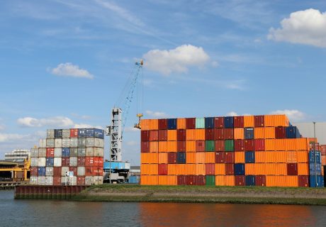 A large orange building sitting next to a body of water