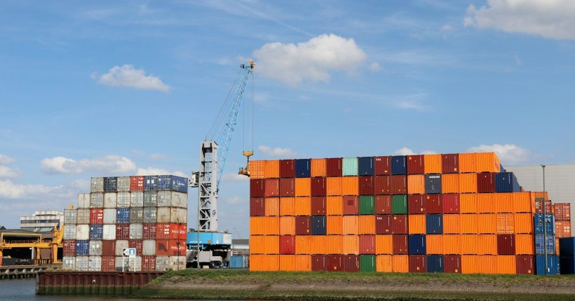 A large orange building sitting next to a body of water