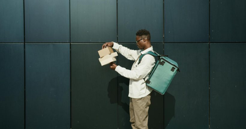 a delivery man looking at packages