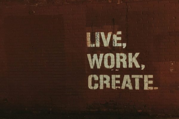 red brick wall with live, work, create. quote