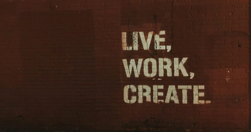 red brick wall with live, work, create. quote