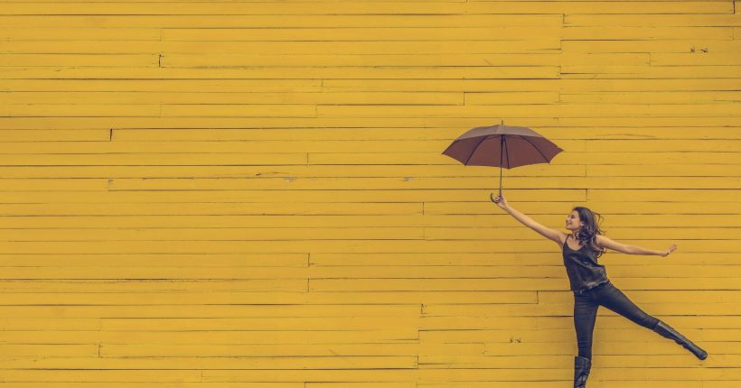 woman holding brown umbrella